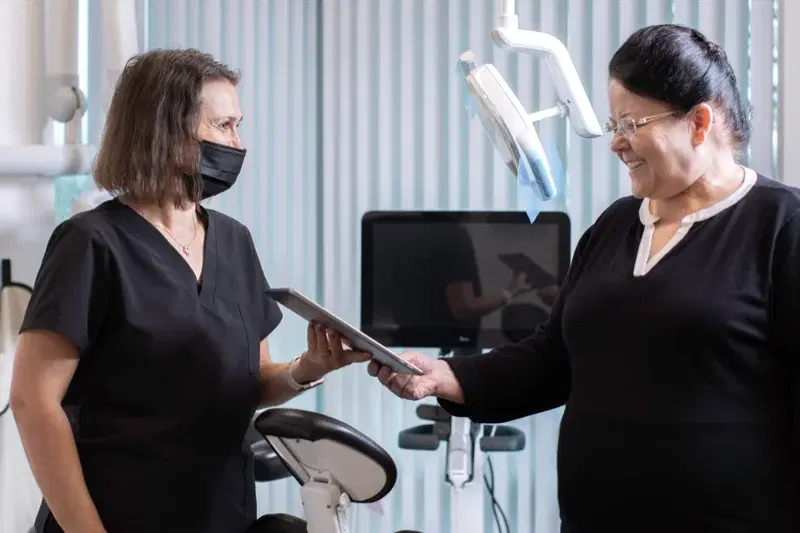 Fusion Dental staff explaining transparent dental pricing to patient